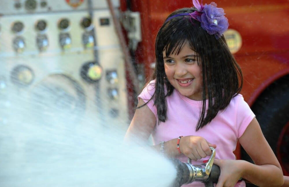 Young girl spraying water.